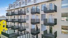 modern multi-story building, balconies, white and grey exterior