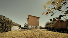 Two-story wooden house with large windows, surrounded by a field of wildflowers and trees. The house appears to be situated in a rural or natural setting with a scenic view.