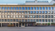 modern office building, multiple windows, large glass entrance, multiple floors, beige color, garage