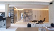 living room with wooden features, modern design, open shelves, armchairs, coffee table, books