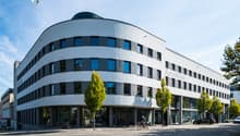modern architectural style, large windows, ArcoWest name, glass entrance