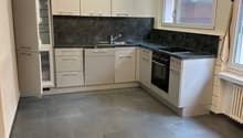 kitchen with white cabinets, granite countertops, stainless steel appliances, tile flooring, large window with daylight