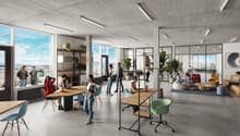 Large open-plan office space with concrete ceiling, floor-to-ceiling windows providing a view, various seating areas including tables, chairs, and lounge furniture, shelving units, and potted plants throughout the space.
