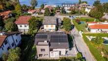 House with solar panels on the roof, located on the lakefront, red tile roofs, fenced gardens