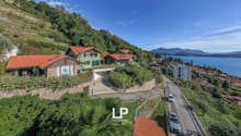 House on a hillside with lake view, red roof, garden, parking place, solar panels