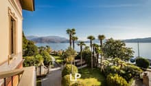 balcony with ocean view, lawn, trees, mountains, mountains in the distance