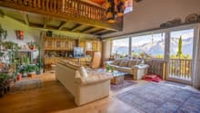 open-plan living and dining room with fireplace, balconies, glass windows with balcony railing, floor-to-ceiling windows, large glass windows, glass doors, couch, glass coffee table, rug, cabinet, TV