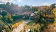 Detached house with garage, aerial view, surrounded by forest