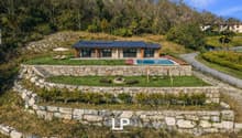 Detached house with solar panels, swimming pool, landscaped garden with stone walls