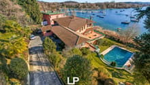 Large house with a swimming pool, located on a hill with a view of the lake