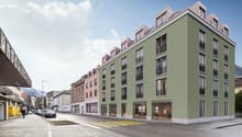 multi-story building, large windows, balconies, street shops, urban setting