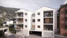 modern building, raised ground floor, balconies, garage, surrounded by mountains