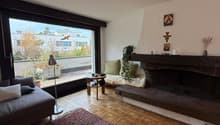 fireplace, couch, rug, lamp, large windows, garden view