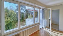 large windows, wooden floor, white walls, balcony, trees view