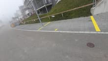 Road with sidewalk with designated parking places