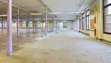 spacious warehouse, concrete floor, large windows, metal columns