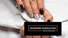 Manicured nails with black and white nail art design.