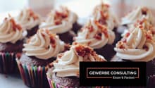 cupcakes topped with whipped cream and bacon bits