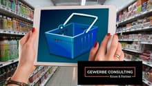 woman holding tablet with a basket on screen inside a supermarket