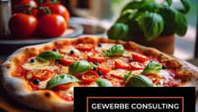 Pizza with tomato, cheese, basil leaves, and black olives