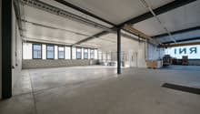 empty room, concrete floor, windows, metal ceiling beams, storage shelves