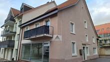 3 story house, brown roof, glass windows, glass door, balcony, glass wall