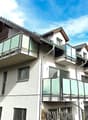 3 story house, white exterior, brown roof, multiple balconies, mountain view