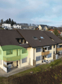 2 story house, brown roof, yellow walls, balcony, car parked in front