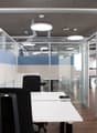 glass walls, white desk, black office chairs, ceiling lamps