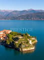 Villa on an island, surrounded by water, mountains in the background