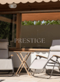 Terrace with two lounge chairs, small table, and view of outdoor surroundings