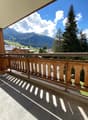 wooden railing, concrete floor, clear view of mountains
