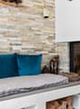 stone wall, fireplace, cushions, decorative elements