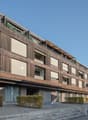 Modern design building with wood panels, balconies, and multiple windows.