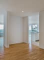 empty room, wooden floor, white walls, large windows, balcony, view