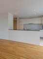 modern kitchen, white cabinets, wooden floor, large windows, balcony