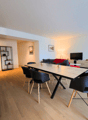 dining area with table and chairs, plant, mirror, TV, couch, shelves, office chair