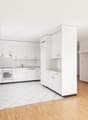 modern design kitchen with all appliances, white cabinets, wooden floor