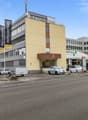 Office building with parking area, located near other buildings