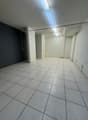 empty room, white tiles, white walls, ceiling lights, door, power outlets