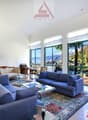 large windows, blue couches, glass coffee table, TV stand, clock, statue, carpet, large windows with mountain views