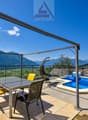 Balcony with pool, metal pergola, table, chairs, swings, view of mountains