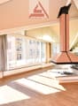large windows, fireplace, wooden floor, spacious layout, city view