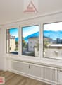 Empty room, large windows, mountain view, white wall, wooden floor