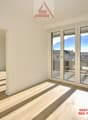 Empty room with sliding doors to a balcony and a view of mountains