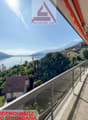 First or second home residence, balcony with glass railing, view of mountains and lake