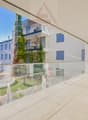 Terrace with glass railings, tiled floor, panoramic views of surrounding mountains and landscape