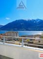 Building with balcony, overlooking mountains and lake