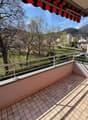 tiled floor, metal railing, view of the mountains and trees