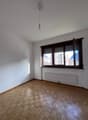 empty room, wooden floor, white walls, large window, radiator, open window